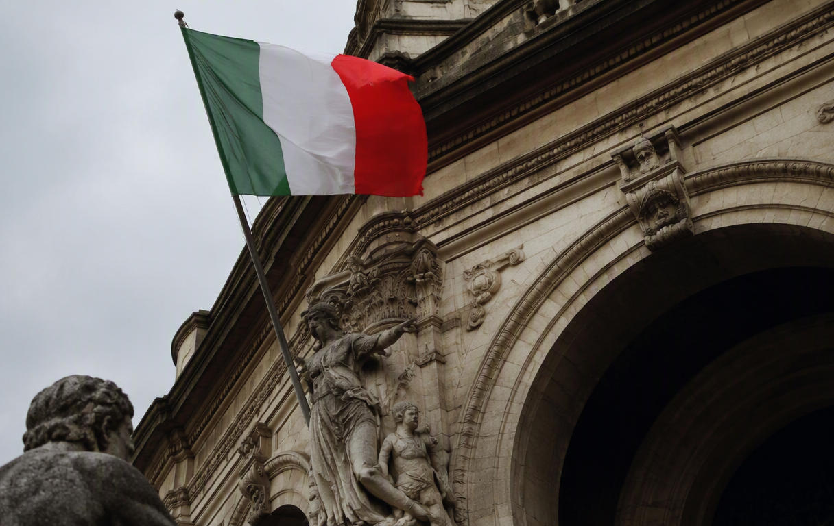 Italian flag waving above ornate courthouse archway