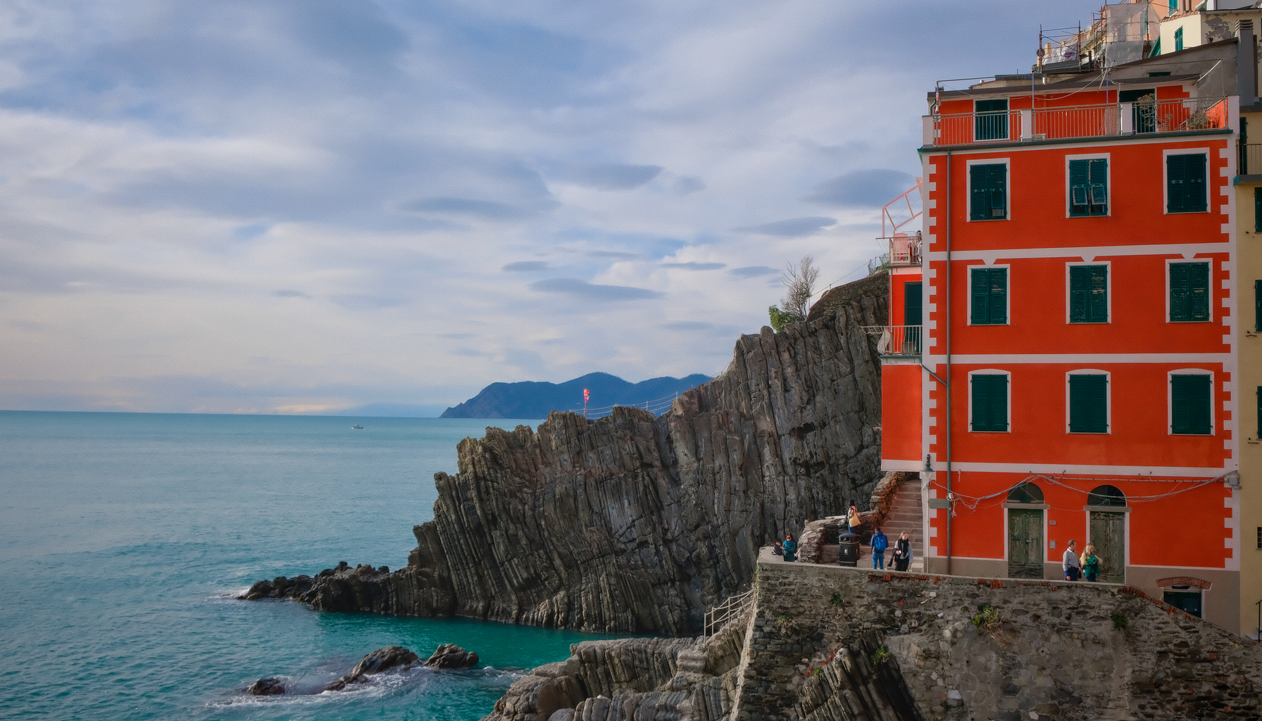 Stunning view of Riomaggiore in Cinque Terre, Italy with its colorful buildings by the sea.