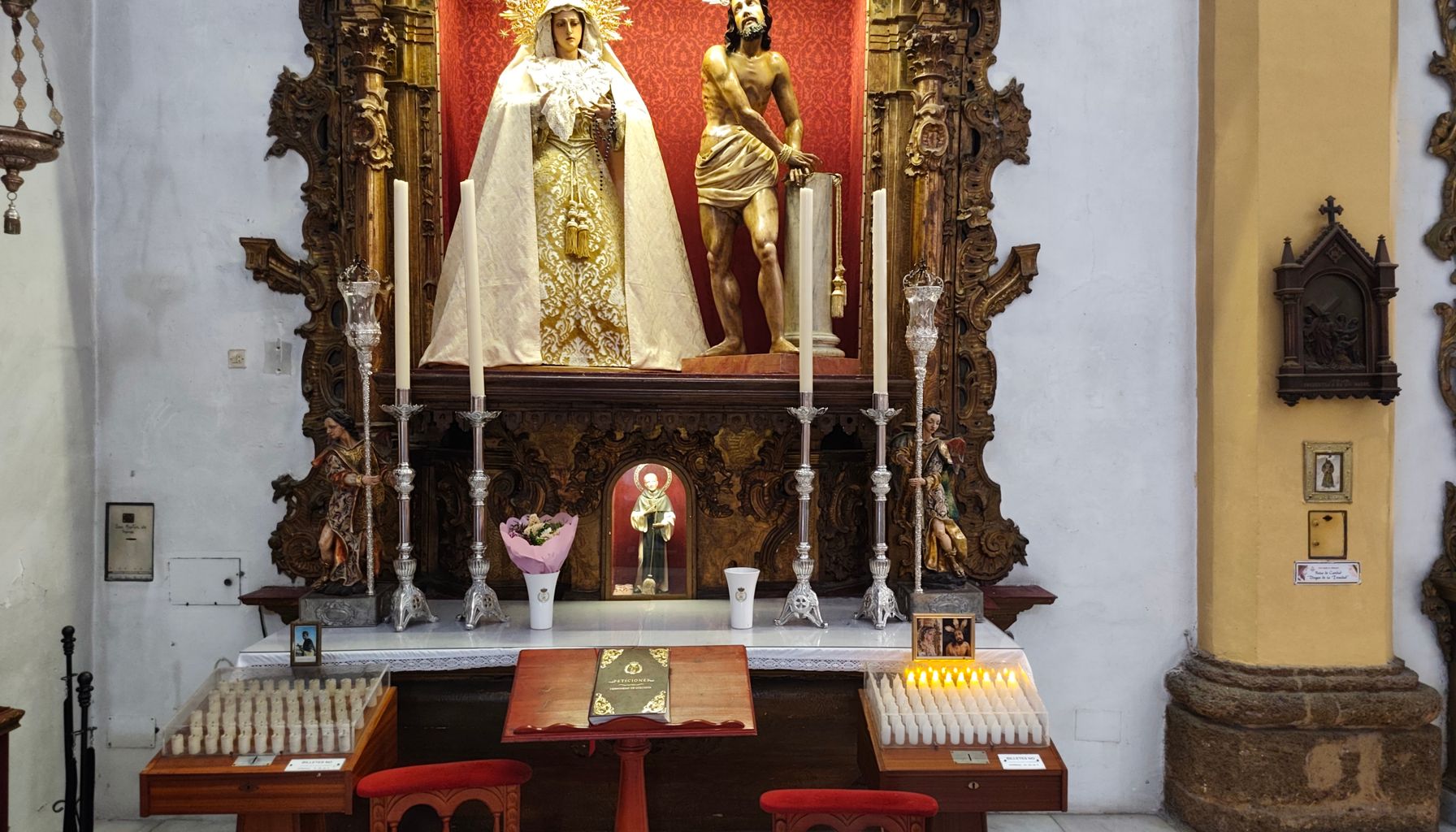 Intricate religious altar featuring statues in a San Fernando, Andalucía church setting.