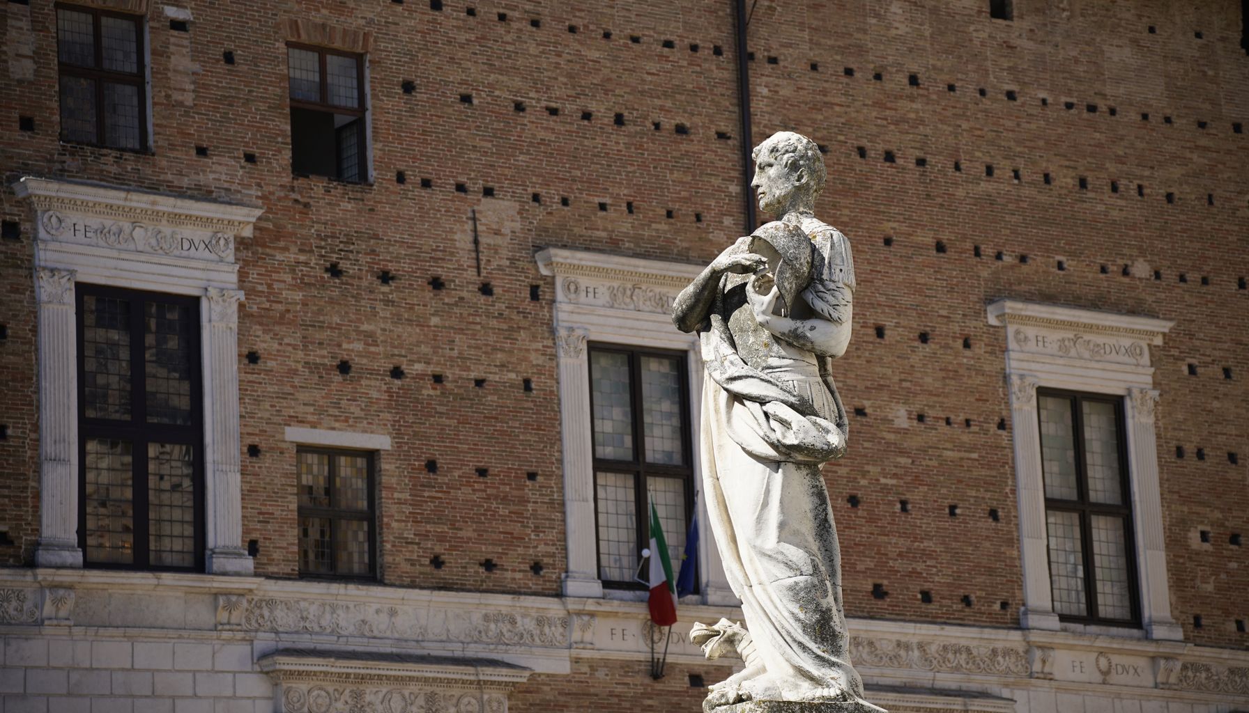 A detailed view of a historic statue at Palazzo Ducale, Urbino, Italy.