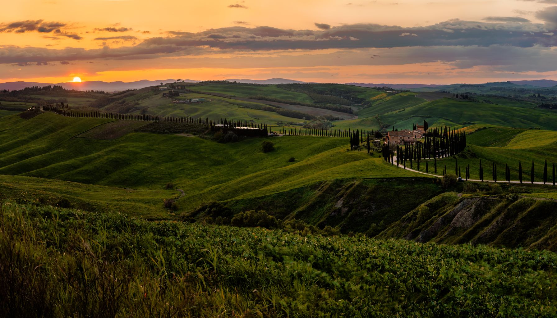Breathtaking sunset over the green hills of Tuscany, Italy.