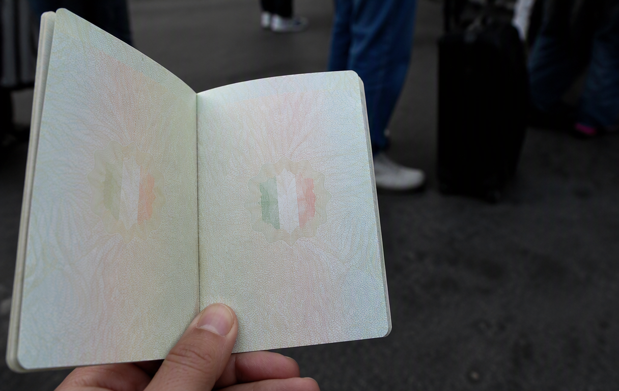 Flat lay of a passport and map, symbolizing travel adventure and exploration.