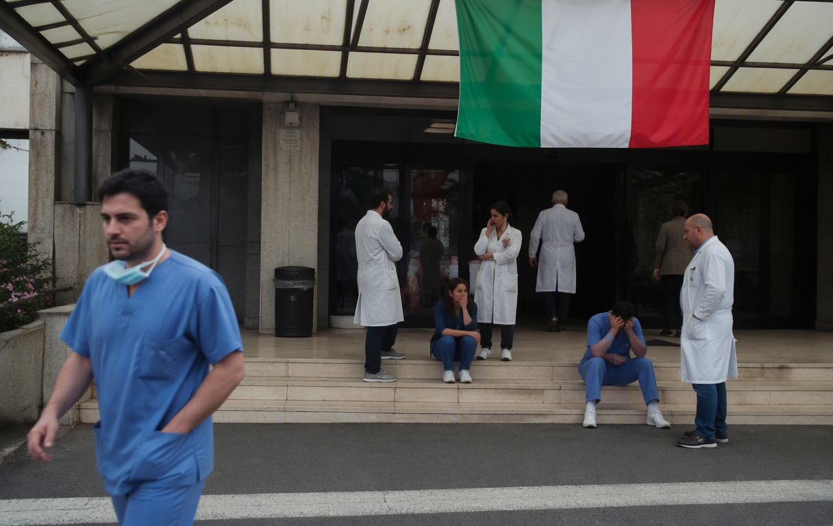 Hospital entrance with Italian flag  medical staff