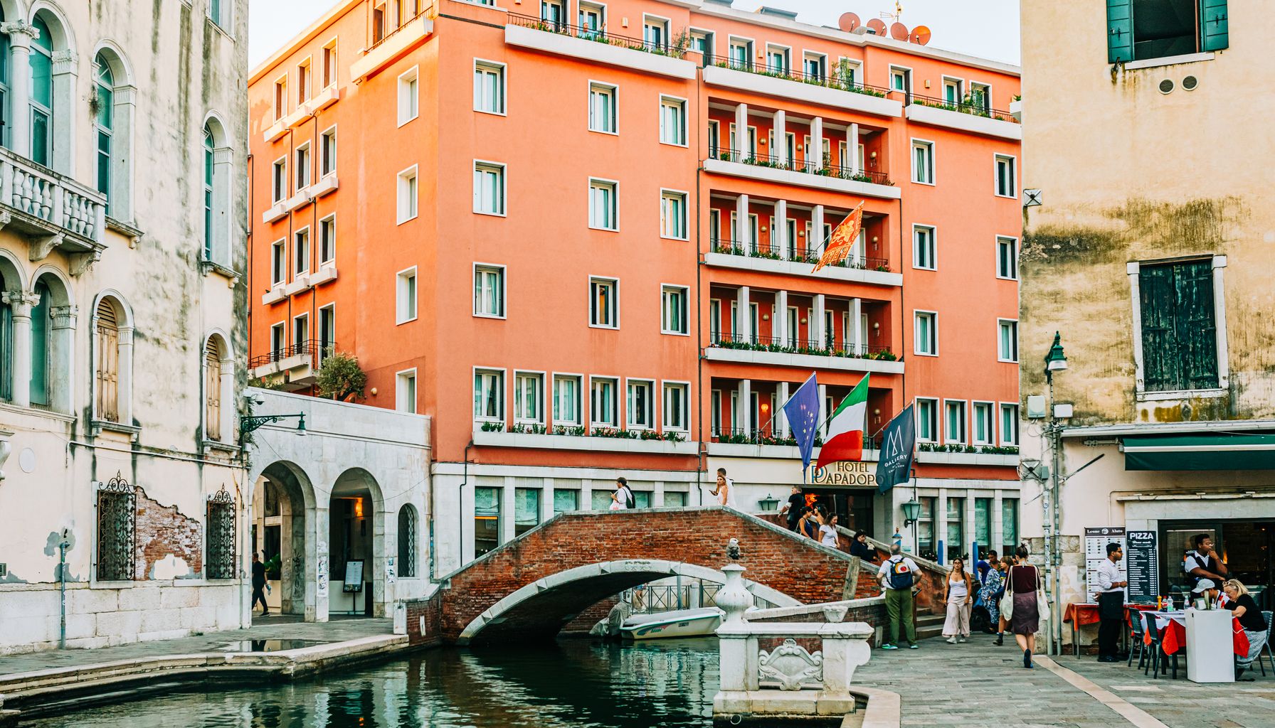 Picturesque view of a Venetian canal with historic architecture and a quaint bridge.