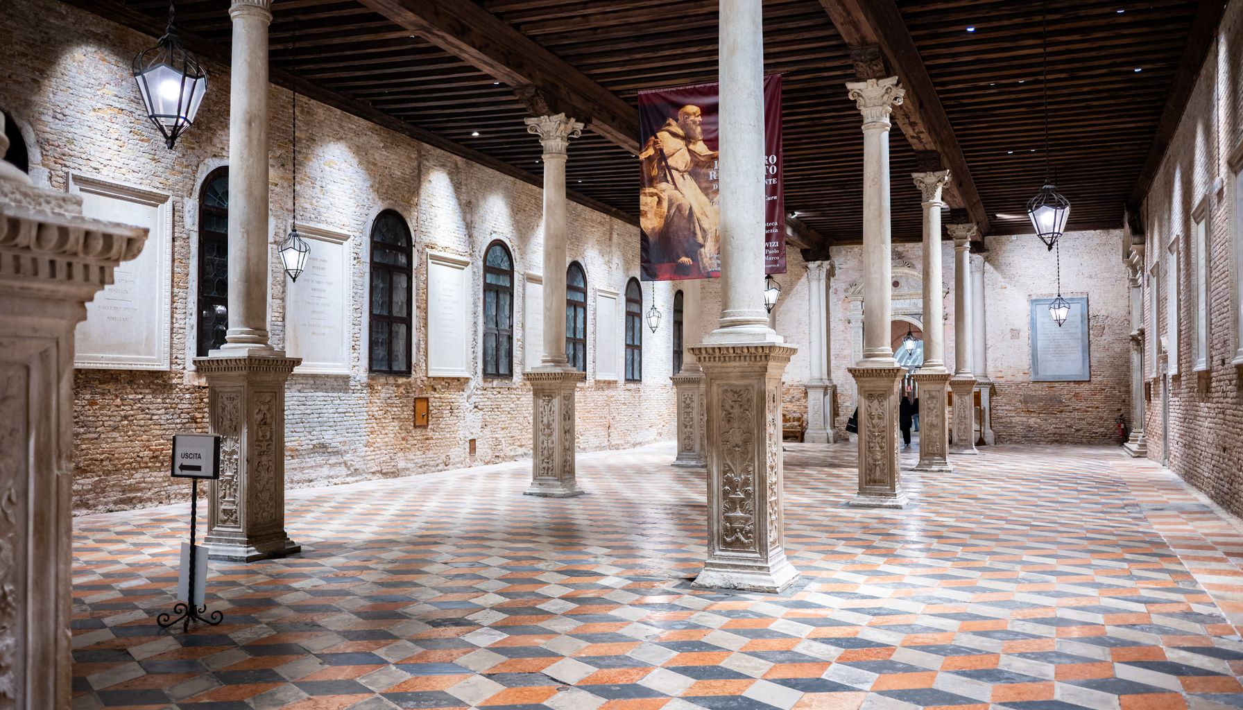 Explore this stunning Venetian interior featuring intricate columns and patterned flooring in Venice, Italy.