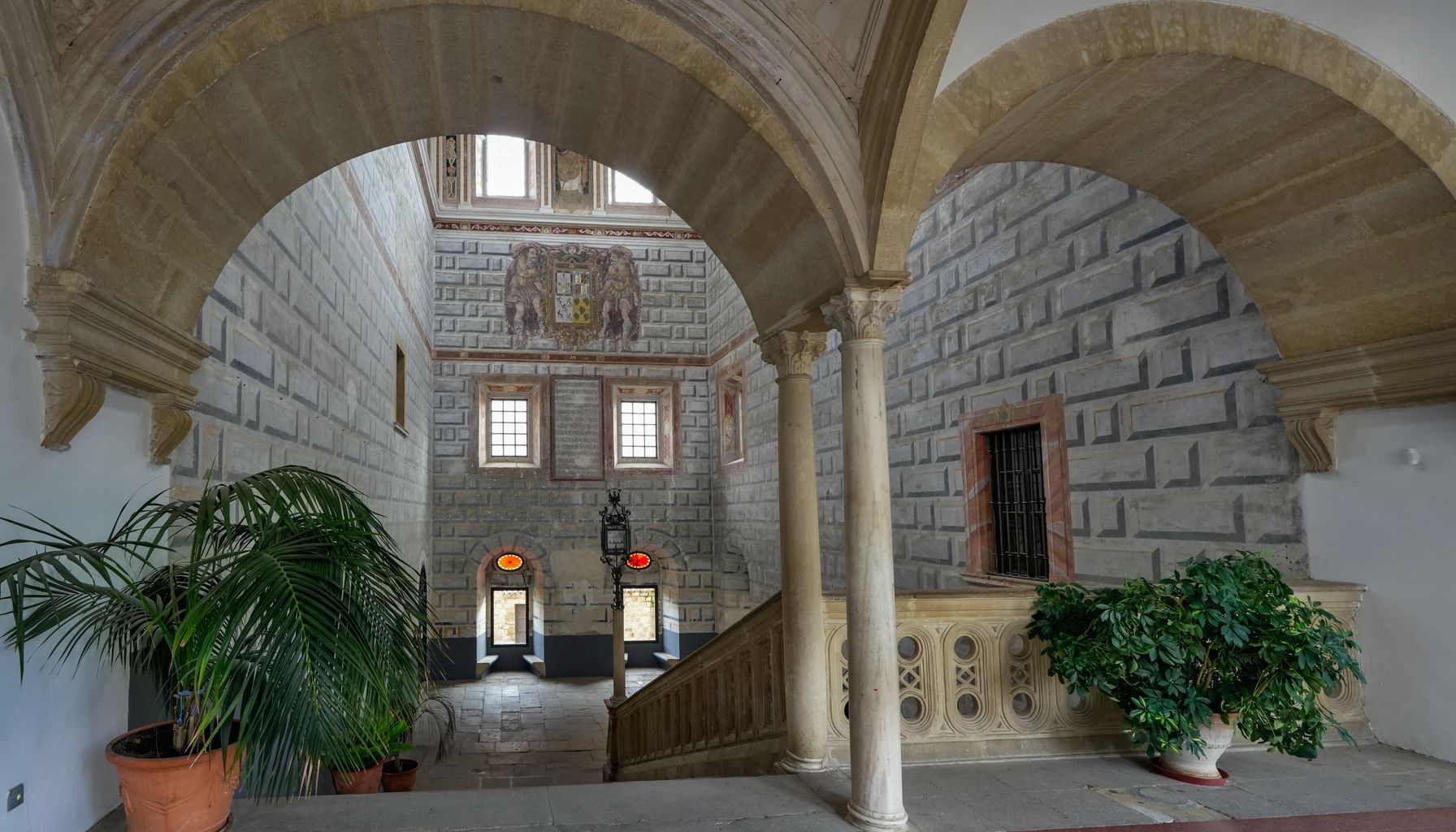 Elegant interior of a historic building in Úbeda, Spain, showcasing arches and detailed stonework.