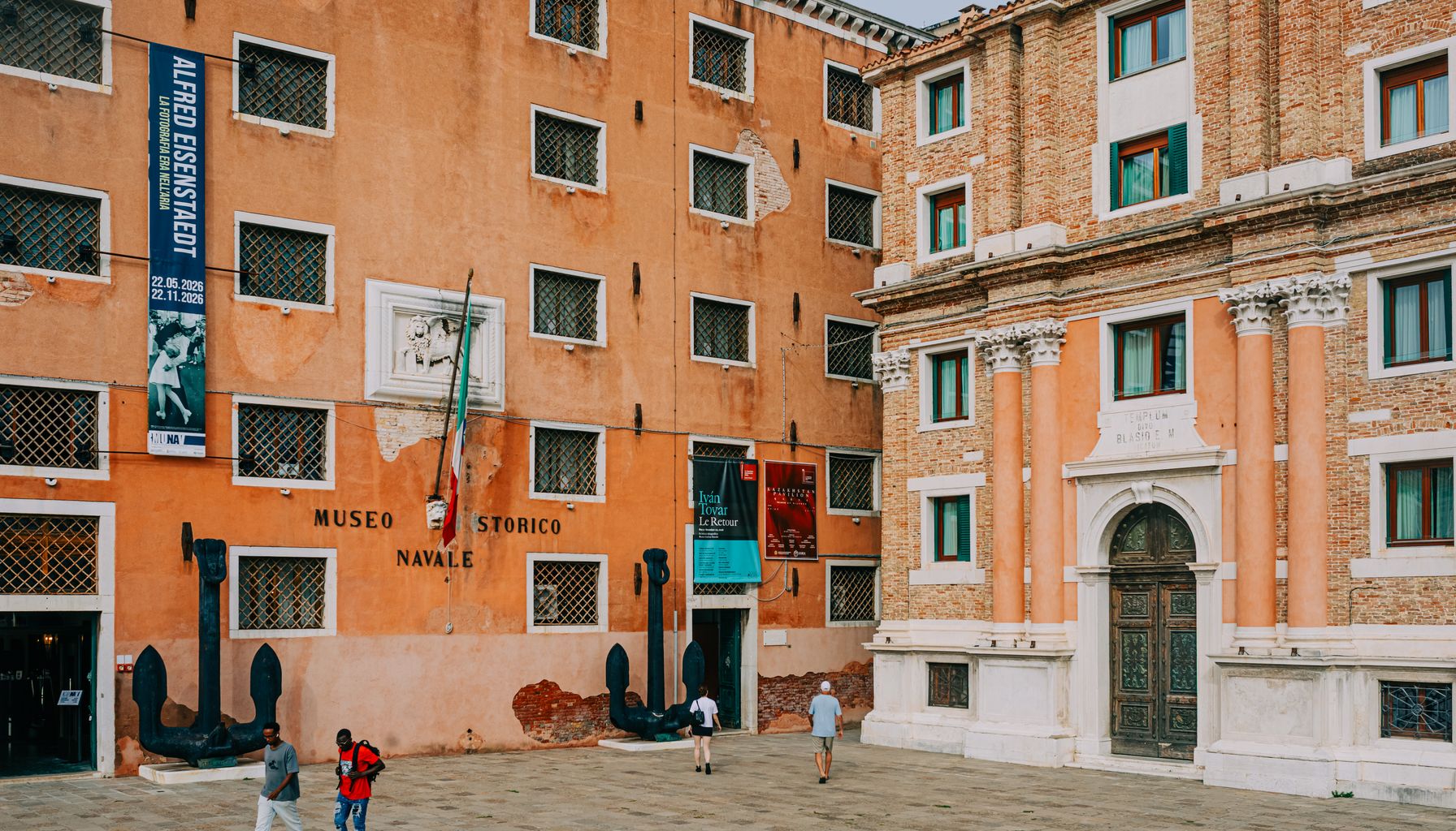 Exterior view of the Museo Storico Navale with people walking nearby in Venice, Italy.