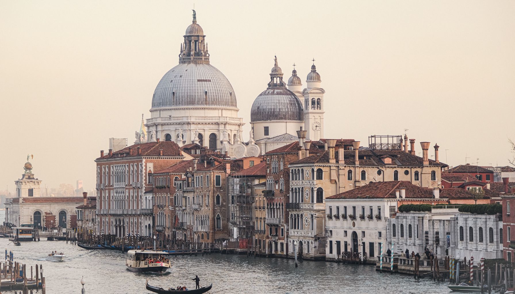 Iconic view of Santa Maria della Salute along the Grand Canal in Venice, Italy at sunset.